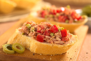Baguette with tuna, green olive and tomato spread