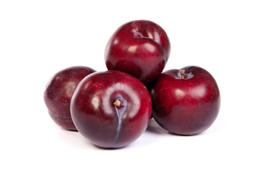 Group of plums  on white