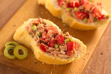 Baguette with tuna, green olive and tomato spread