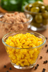 Sweet corn kernels in glass bowl with tuna and olives