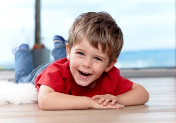 Fotobehang three years old boy on the floor, having fun © Günter Menzl