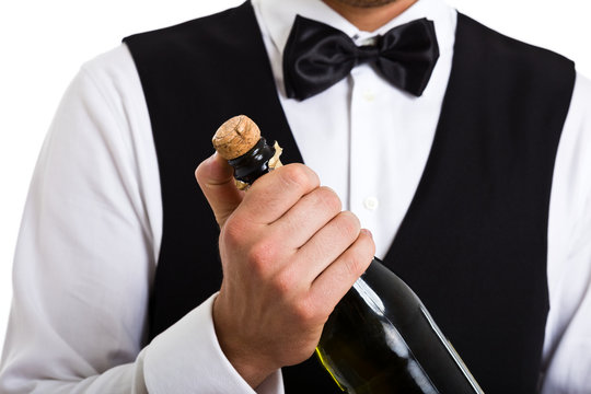 Waiter uncorking a champagne bottle