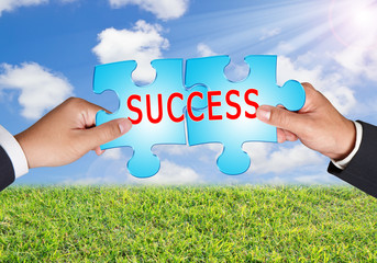 Business hands and puzzle on blue sky