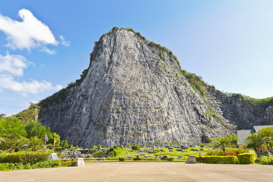 Carved buddha image on the cliff