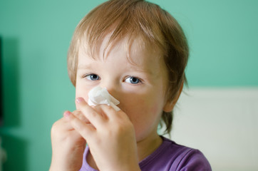 Little boy cleaning nose