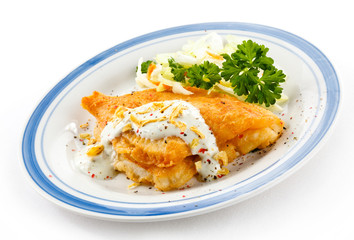 Fish dish - fried fish fillets and vegetable salad