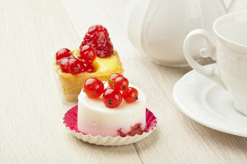fruit pastry little cake with tea cup on white wooden table