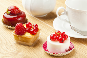 fruit pastry little cake with tea cup on  wooden table