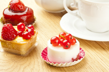 fruit pastry little cake with tea cup on  wooden table