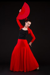 Young woman dancing flamenco with fan