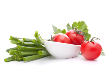 Spring onions and cherry tomato in bowl