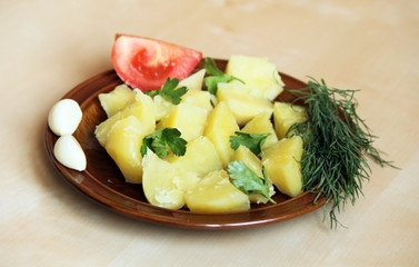 Boiled potatoes and greens with tomato
