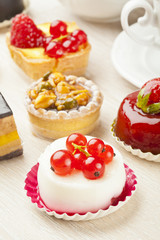 Different sort of beautiful pastry, small colorful sweet cakes