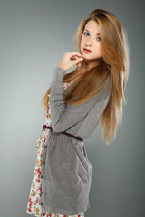 A beautiful young woman is in brown clothes