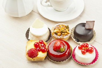 Different sort of beautiful pastry, small colorful sweet cakes