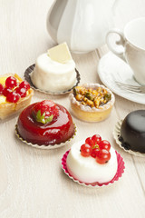 Different sort of beautiful pastry, small colorful sweet cakes