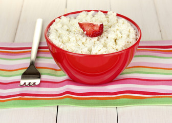 cottage cheese with strawberry in red bowl and fork