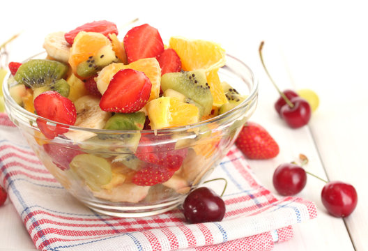 glass bowl with  fresh fruits salad and berries