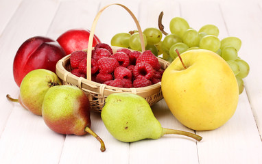 ripe sweet fruits and berries on wooden background
