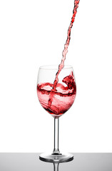 Red wine pouring into the glass