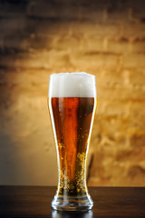 Glass of beer against a stone wall