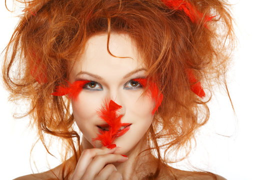 beautiful redheaded girl with red feathers