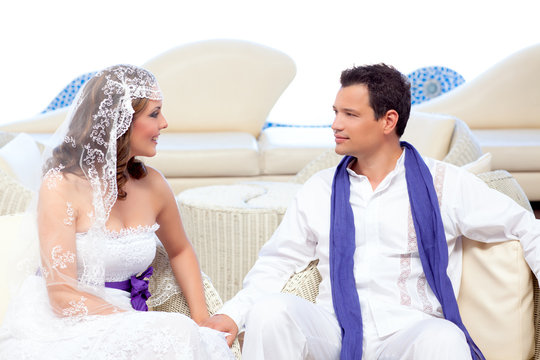 Couple in wedding day relaxed in white terrace