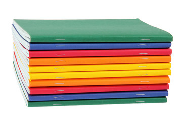 multicolored exercise books over the white background