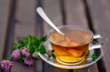 Cup of tea with pink clover