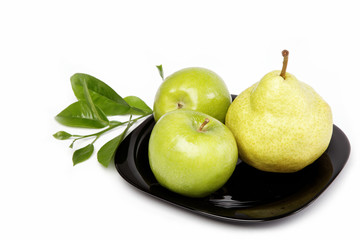 Fresh fruit. Apples and pears on a plate isolated over white bac