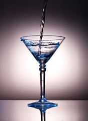 Pouring liquor into a martini glass
