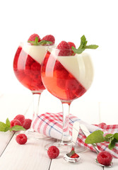 fruit jelly with raspberries in glasses on wooden table