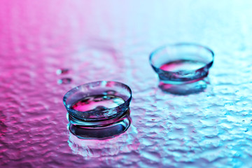 contact lenses, on pink-blue background