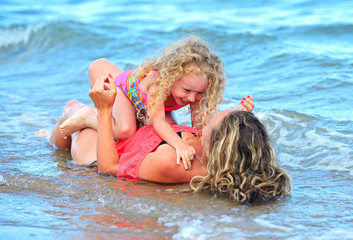 mother with daughter on beach