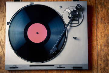 Vintage turntable with disc on wood