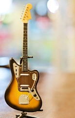 Old guitar toy close-up on wooden table