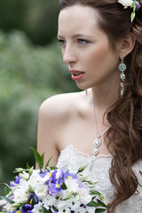 Closeup of young beautiful bride with flowers.