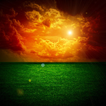 A fine green meadow All on storm sky sunset