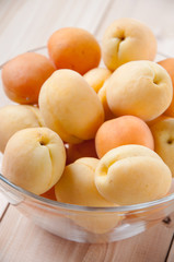 Naklejka na ściany i meble Glass bowl with ripe apricots, close-up