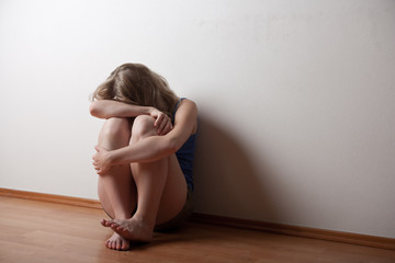 depressed young lonely woman girl, sitting on the floor alone 