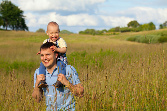 father and child on summer field