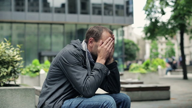 Sad, depressed young man in the city