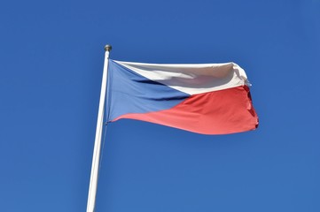 Flag of the Czech Republic fluttering over blue sky
