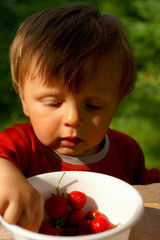 Child eating strawberry