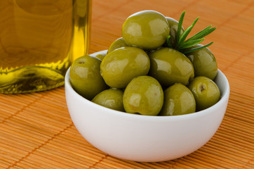 Green olives in a white ceramic bowl