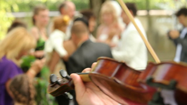 Close-up  on a person playing the violin on a wedding