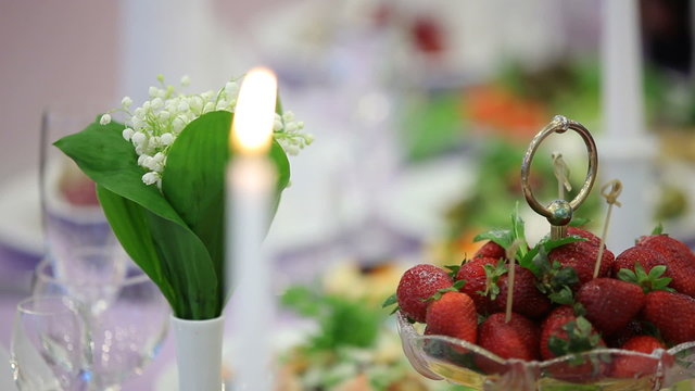 Close up on a candle that burns on a dinner table