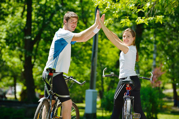 Fototapeta premium Happy couple riding bicycle outdoors
