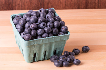 Blueberries in container and on table