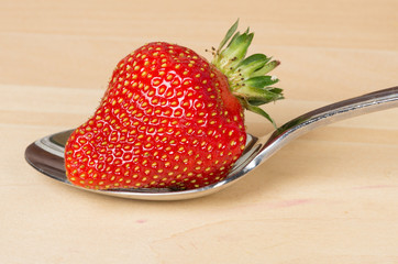 Strawberry on metal spoon